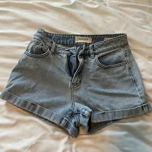 TWO pairs of blue and black jean shorts